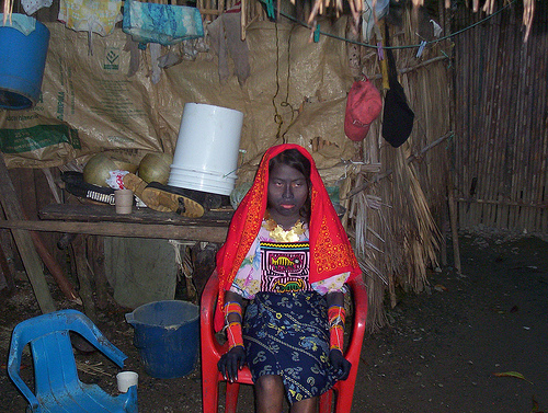 Kuna girl having a puberty ceremony, painted in black